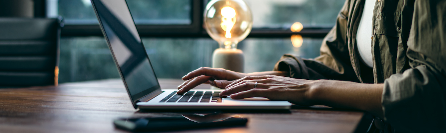 woman tying on laptop
